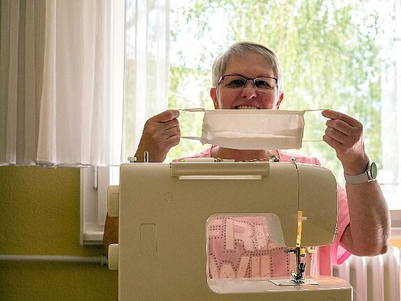 Sigrid Oberwalder zeigt eine der Masken, die im Projekt entstanden sind. Foto: Sulamith Sallmann