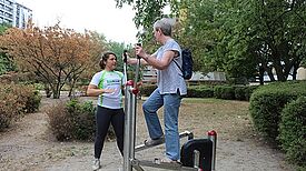 Die Trainerin erklärt einer Anwohnerin die Funktion des Sportgeräts. Foto: M. Hühn, QM Mehringplatz
