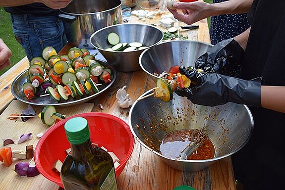 Aus frischem Gemüse bereiteten mehrere Personen Spieße für den Grill beim Sommerfest im QM-Gebiet Germaniagarten vor.