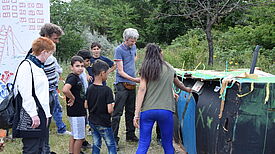 Die Kinder erklären Petra Pau (links) die Ideen hinter dem „Ausländerhaus mit Herz“. Bild: QM Kastanienallee.