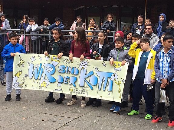 Mit einer Demonstration eröffneten die jungen Künstlerinnen und Künstler der Jens-Nydahl-Schule ihre Ausstellung am Kottbusser Tor. Bild: Kotti Coop e.V.